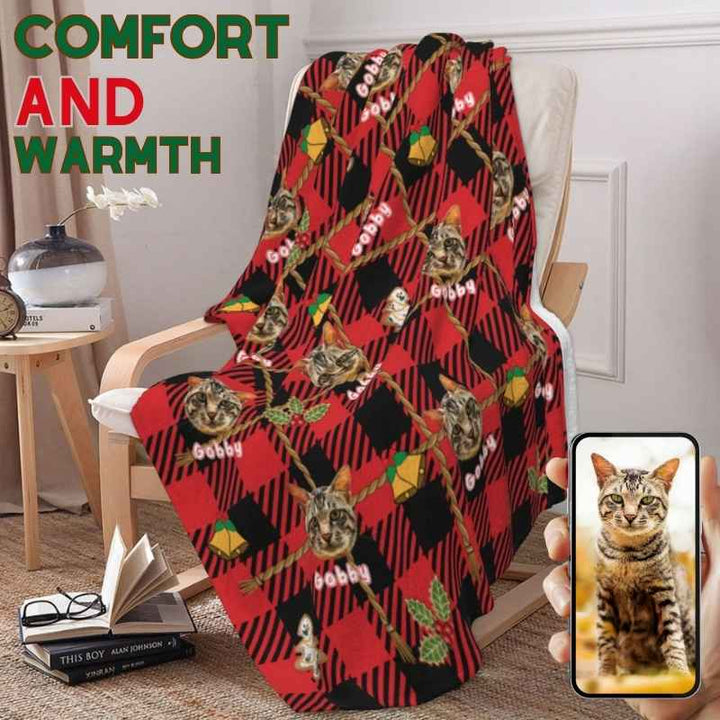 Custom cat photo blanket with festive plaid design, draped over a chair, perfect for cozy holiday gifts.